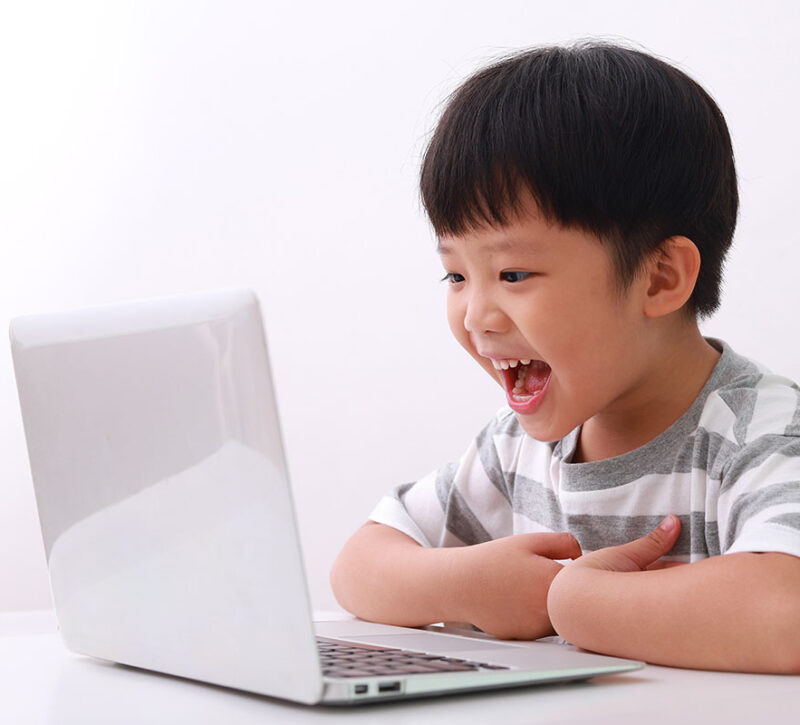 Young boy learning from a computer